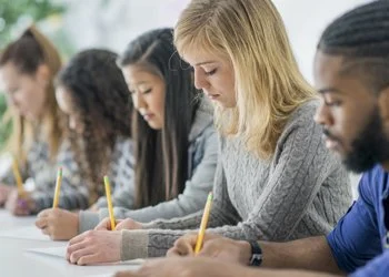 A line of students doing an exam.