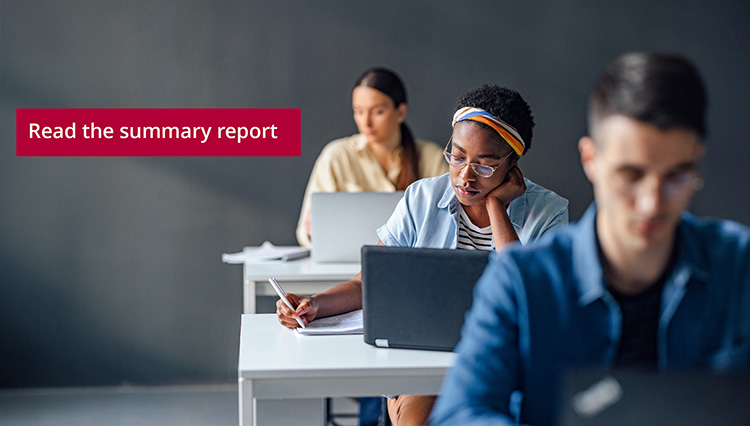 Students in a classroom setting are focused on their laptops, with a prominent 'Read the summary report' text displayed.